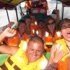 Travelers enjoy the sea spray on a speed boat ride from Panama to Colombia on board the Darien Gapster